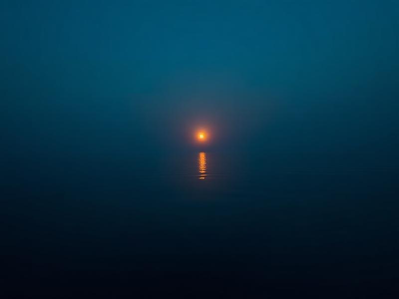 Sunrise reflecting on calm water, the start of a morning water blessing ritual