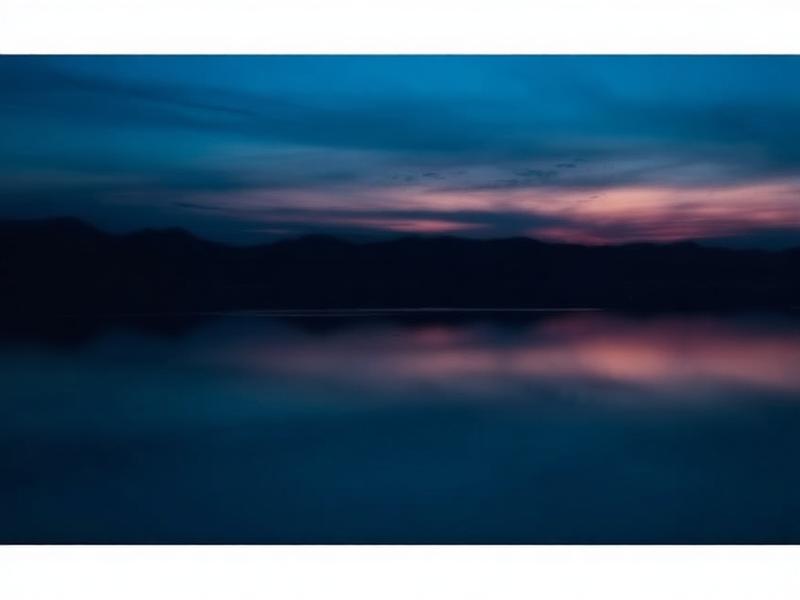 Deep blue sunset over still water for evening water blessing reflection